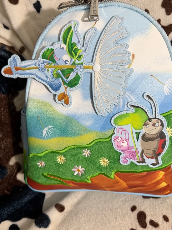 Loungefly Handbags - Loungefly pastel blue garden character mini backpack Bugs Life